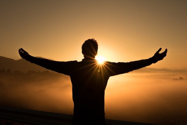 Man with sun in background abundance